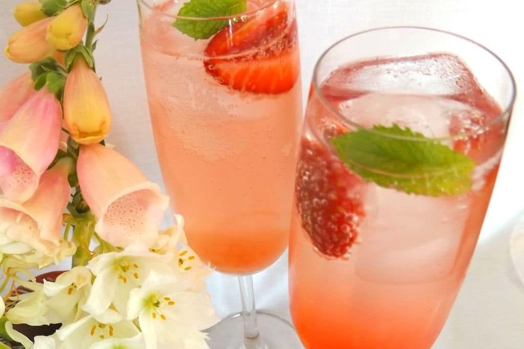 pink drinks in flutes with garnish