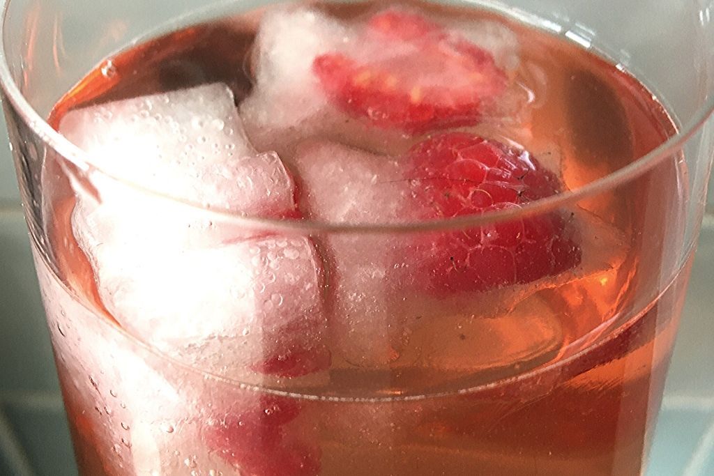 pink drink with raspberry ice cubes