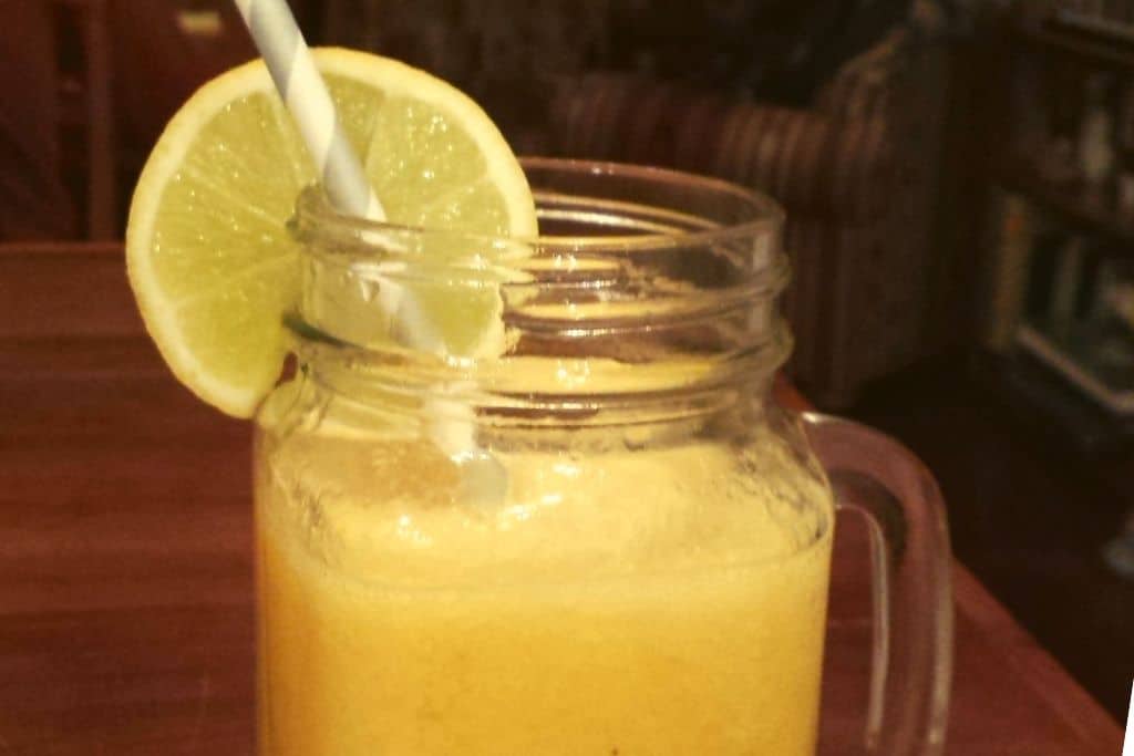 yellow drink with lemon slice and straw