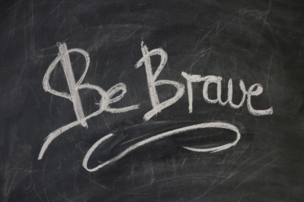 the words 'be brave' on blackboard
