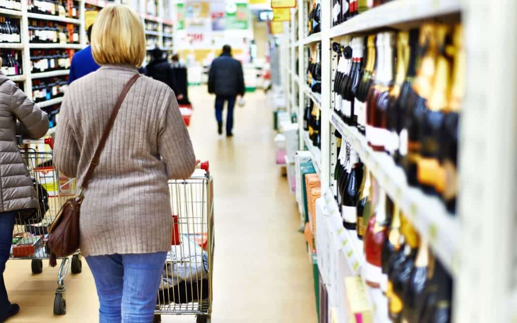 lady in supermarket wine aisle