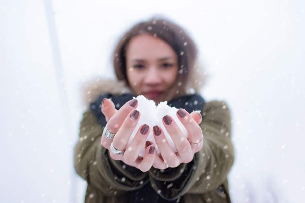 girl holding snowball