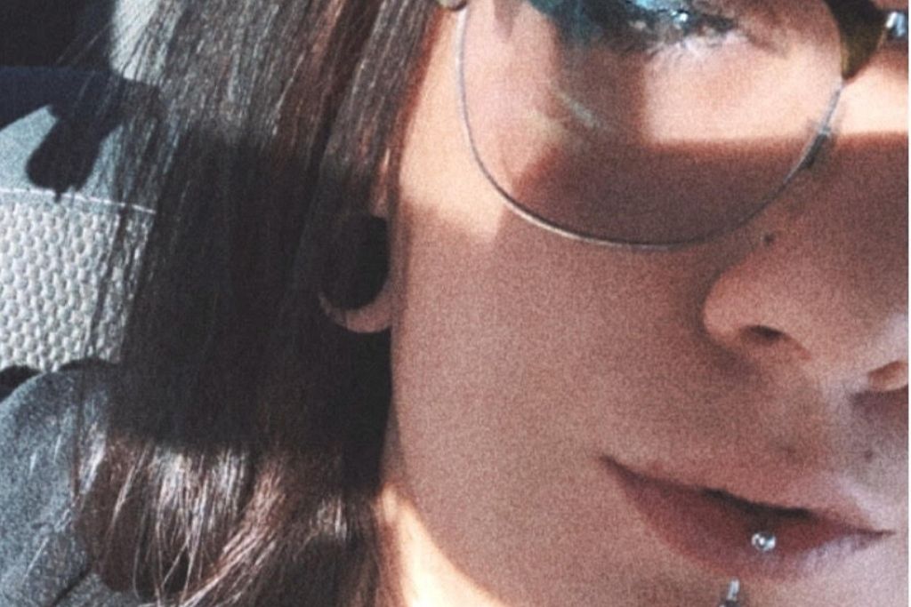 close up kailey with sunglasses on and facial piercing