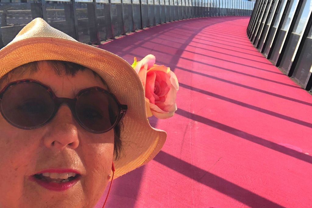 zoe with hat on pink walkway