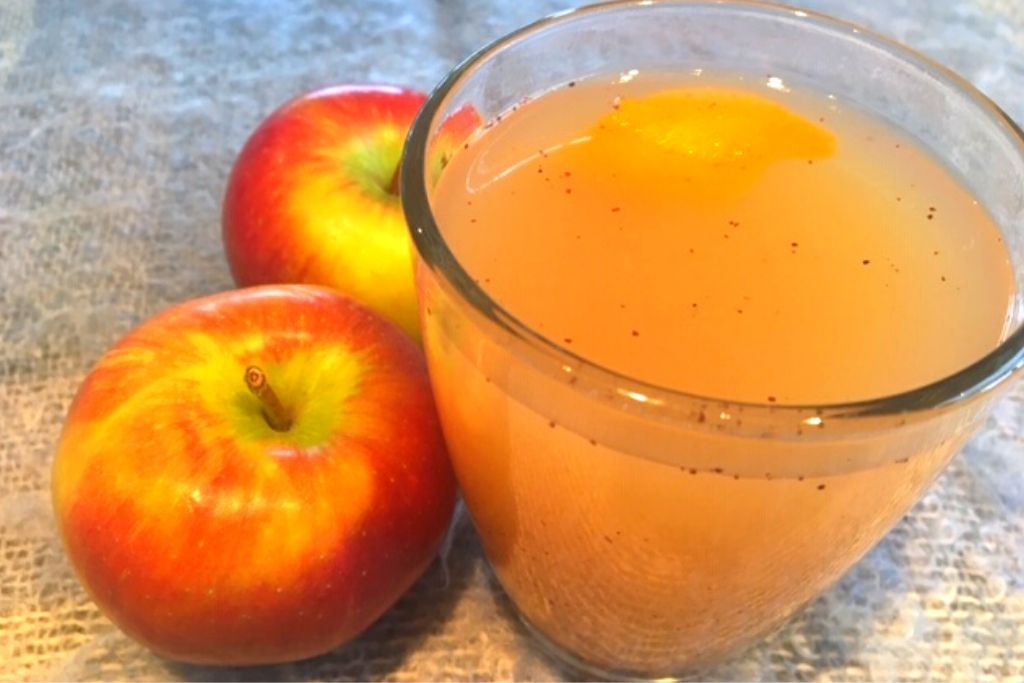 apple juice in glass and apples