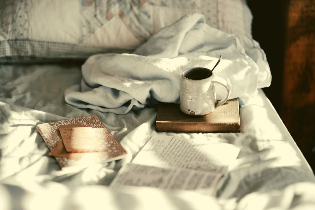 cosy bed with mug and book