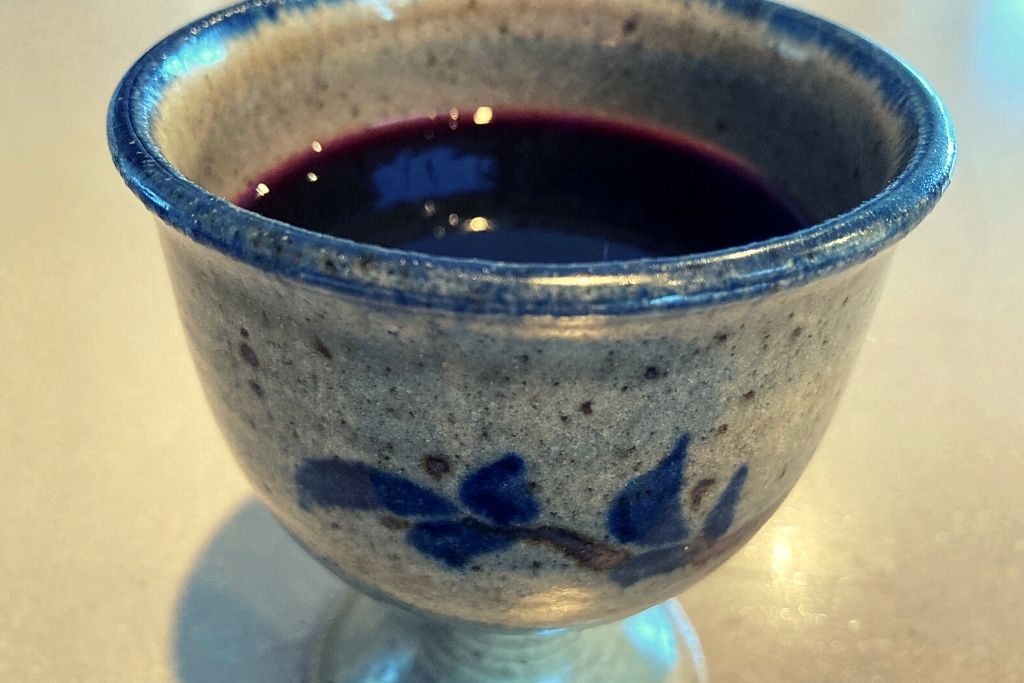 grape juice in ceramic goblet
